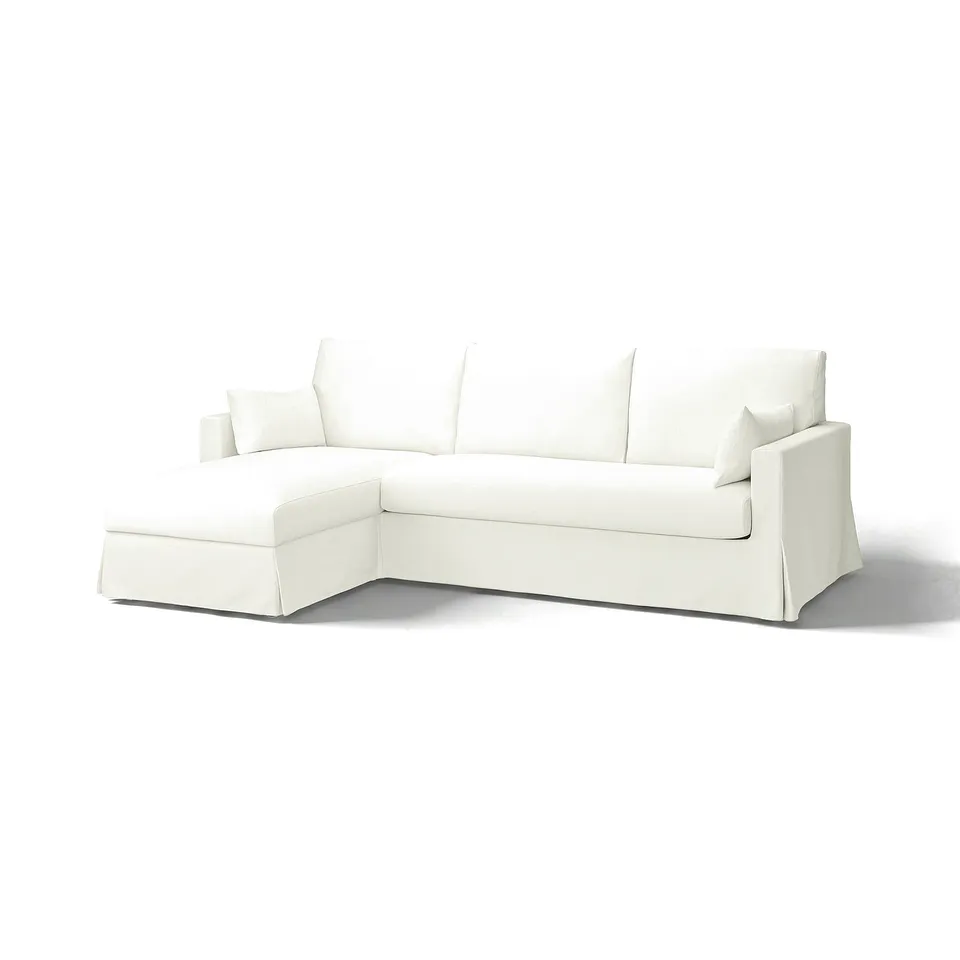 A white, l-shaped HYLTARP sofa with a durable, semi-soft cotton-polyester blend fabric. It has a clean, minimalist design.