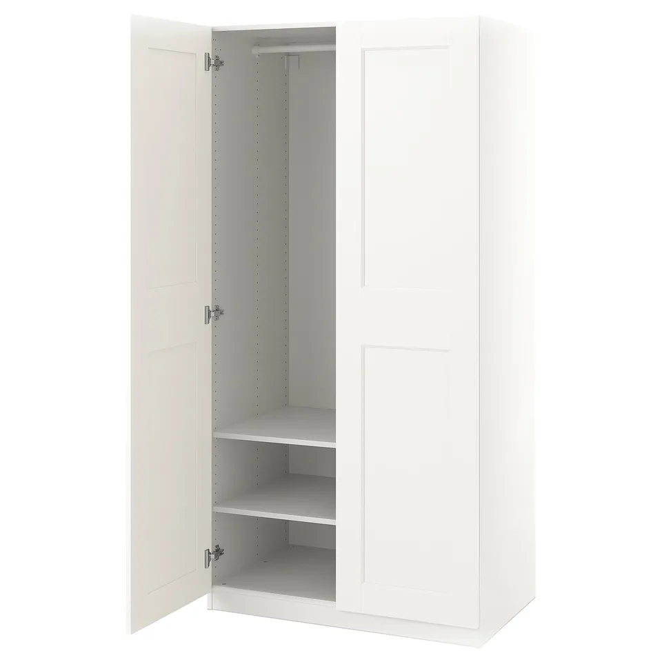 A white ikea PAX wardrobe with one door open, revealing adjustable shelves inside.