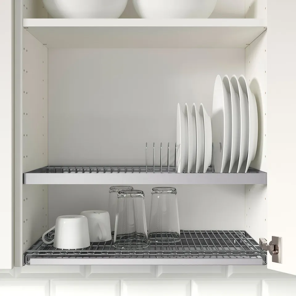 Kitchen cabinet with UTRUSTA dish drainer, storing plates and cups, freeing counter space.