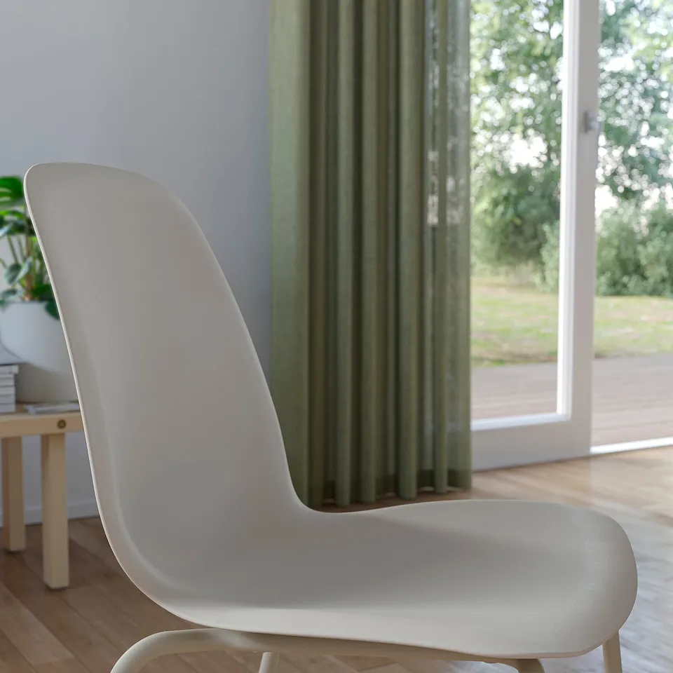 Modern white curved chair near window
