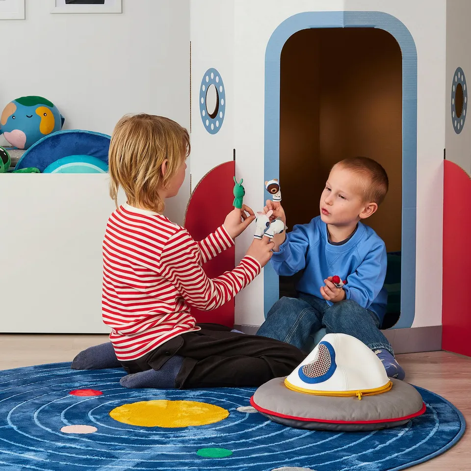 Kids playing with finger puppets in a cosy playroom, enhancing imagination and storytelling.