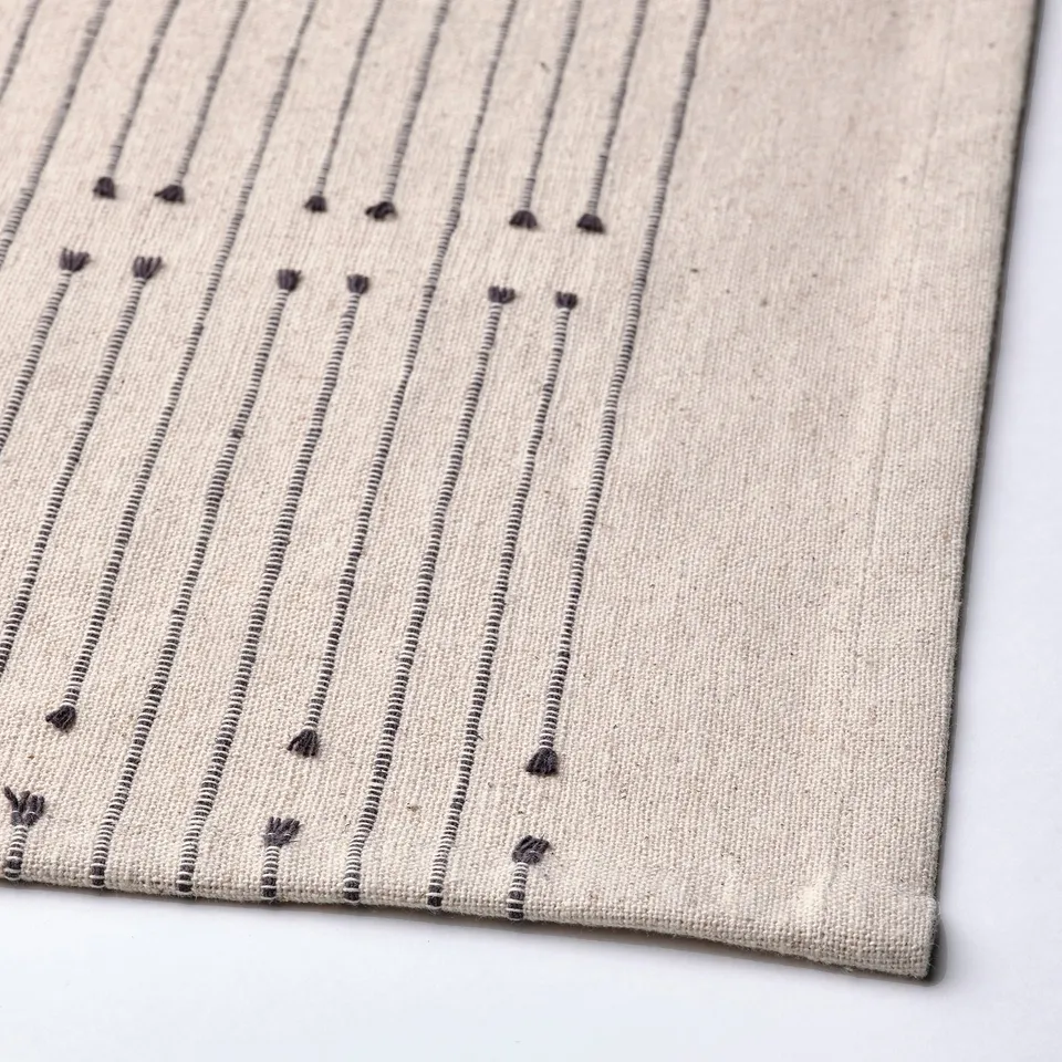 Stylish VÅRARV table runner with subtle stripes and small tassels, showcasing high-quality cotton and jute fabric.