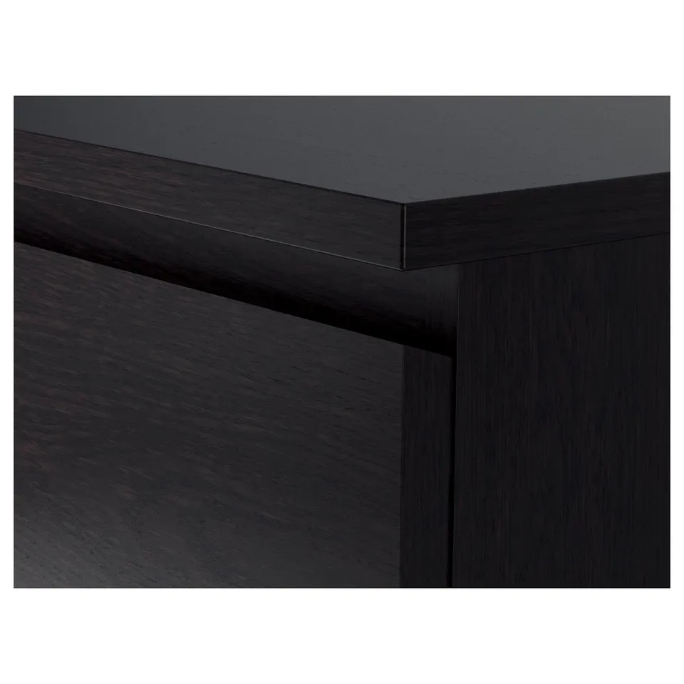 Dark wooden chest of drawers corner detail, smooth finish, clean edges.