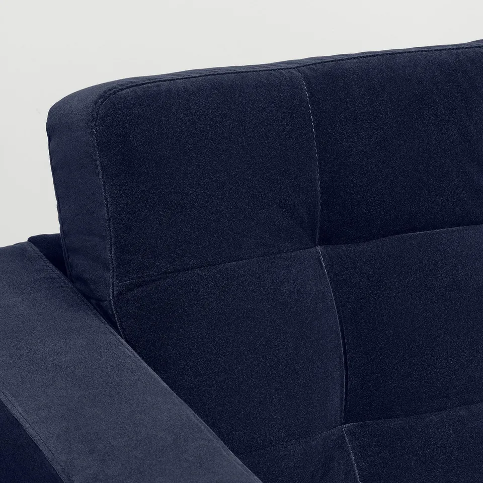 Close-up of a dark grey fabric armchair, showing its tailored design and high-quality upholstery.