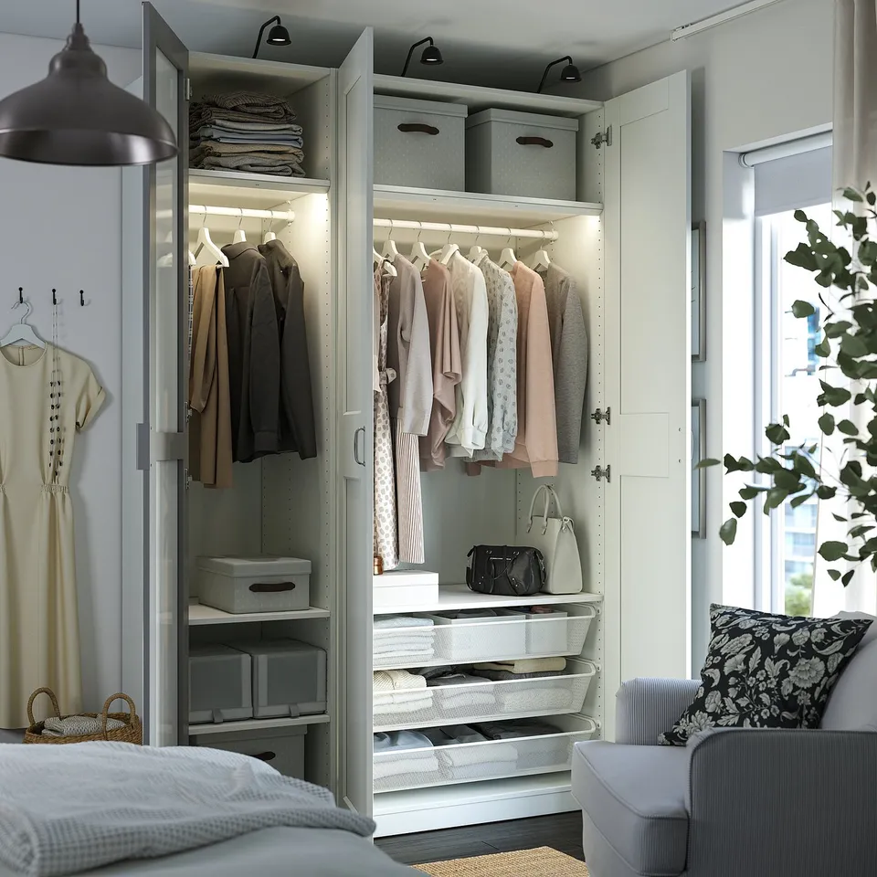 Wardrobe with mirror doors, hanging clothes, shelves, and drawers. Led lighting illuminates the interior.