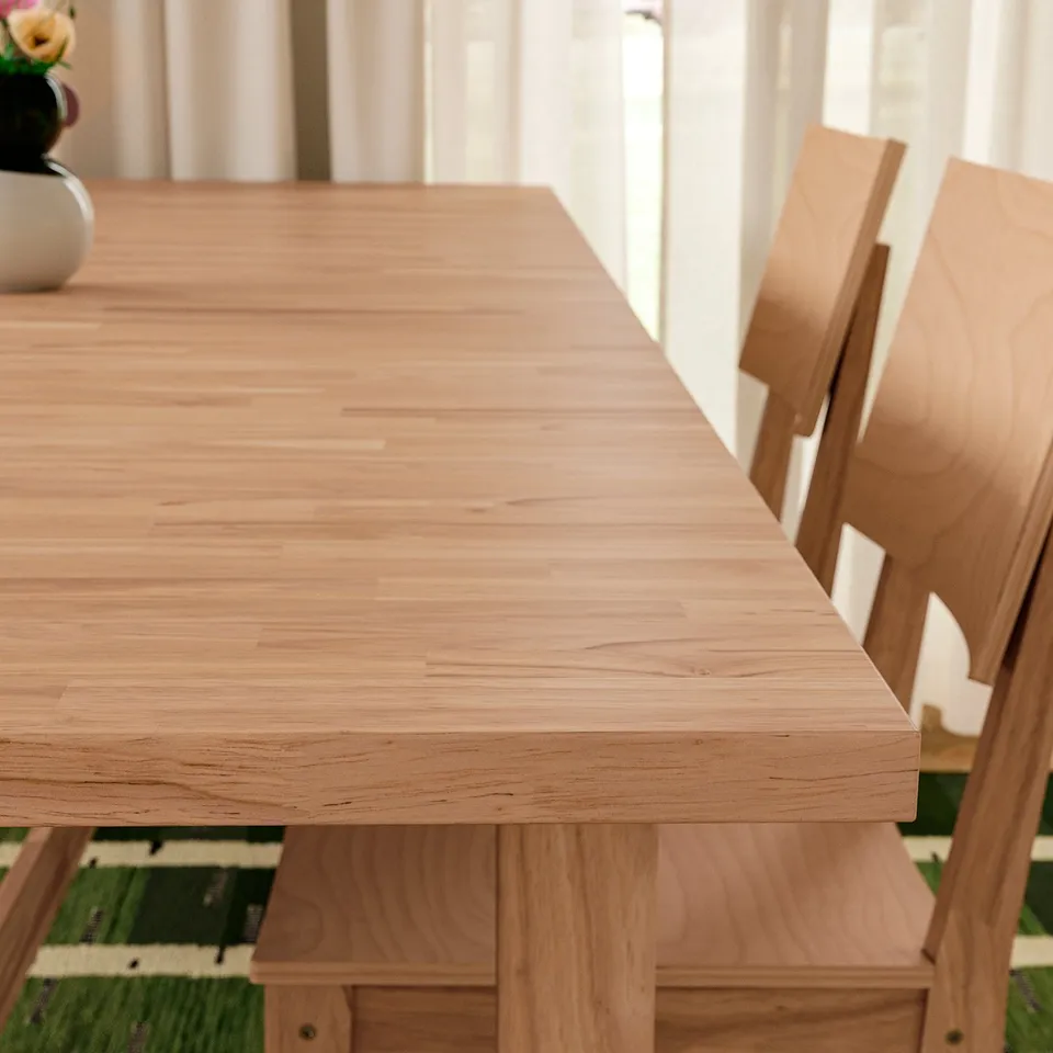 Polished wooden table & chair on patterned rug.
