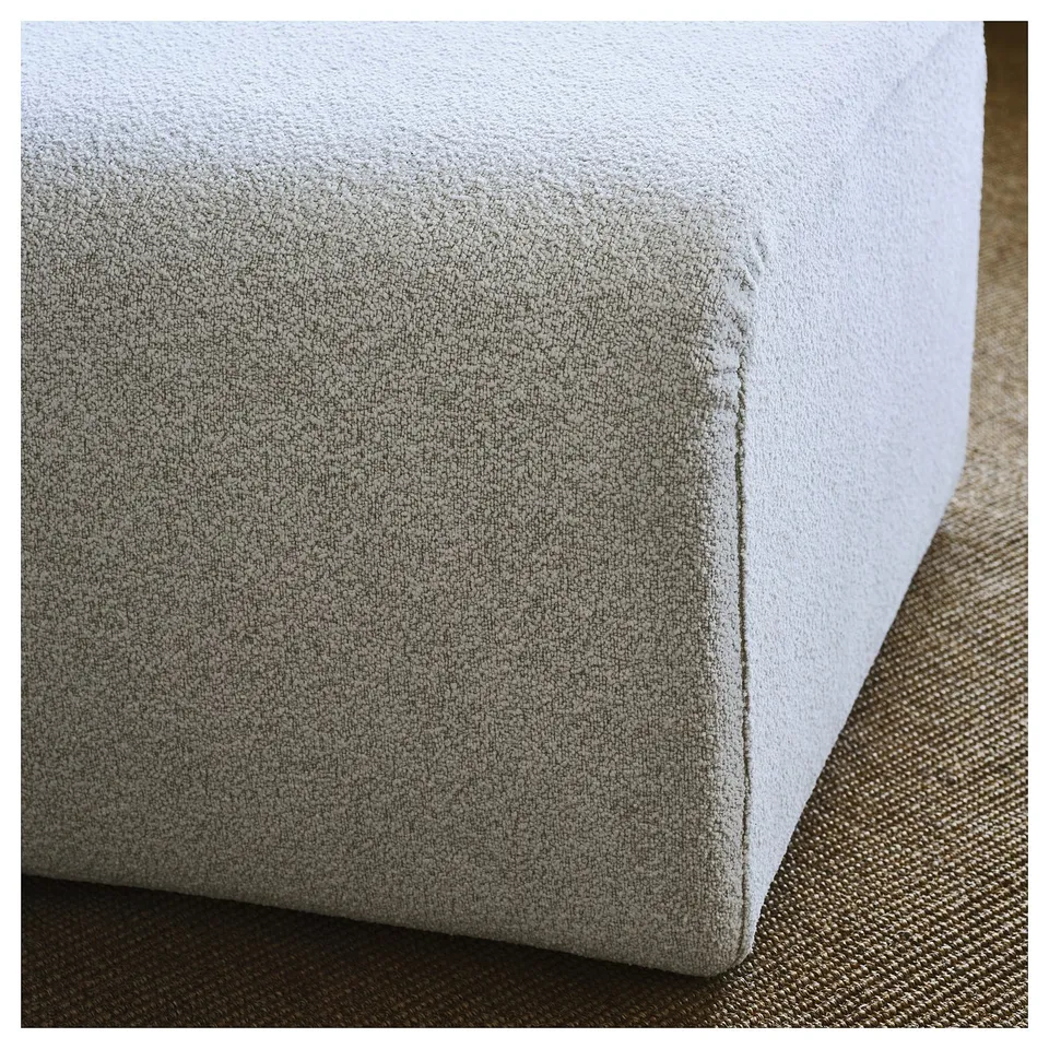 Close-up of cushion on modern fabric chair, showcasing smooth texture and sleek design.