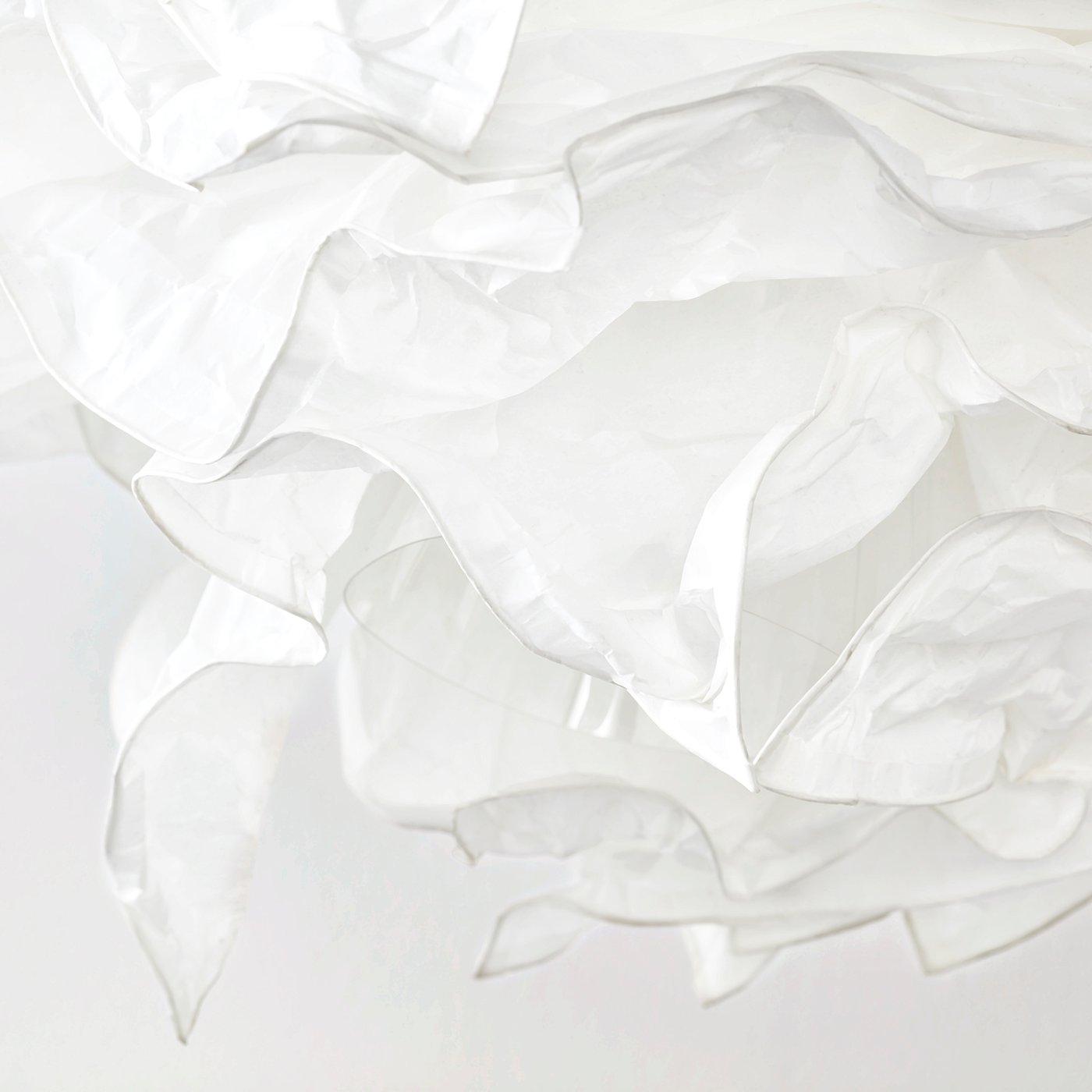 Soft, textured white paper lamp shade with gentle folds and wrinkles, emitting a warm, diffused light.