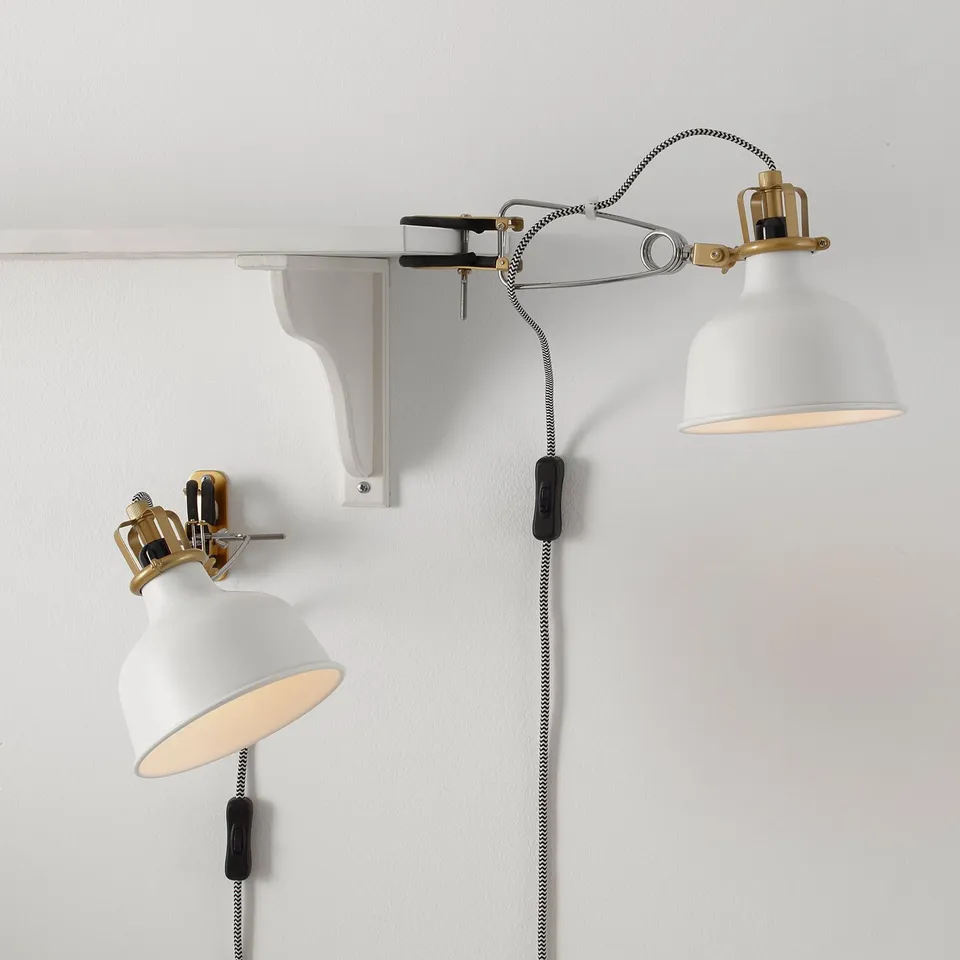 Two adjustable clamp lamps with white shades and striped cords.
