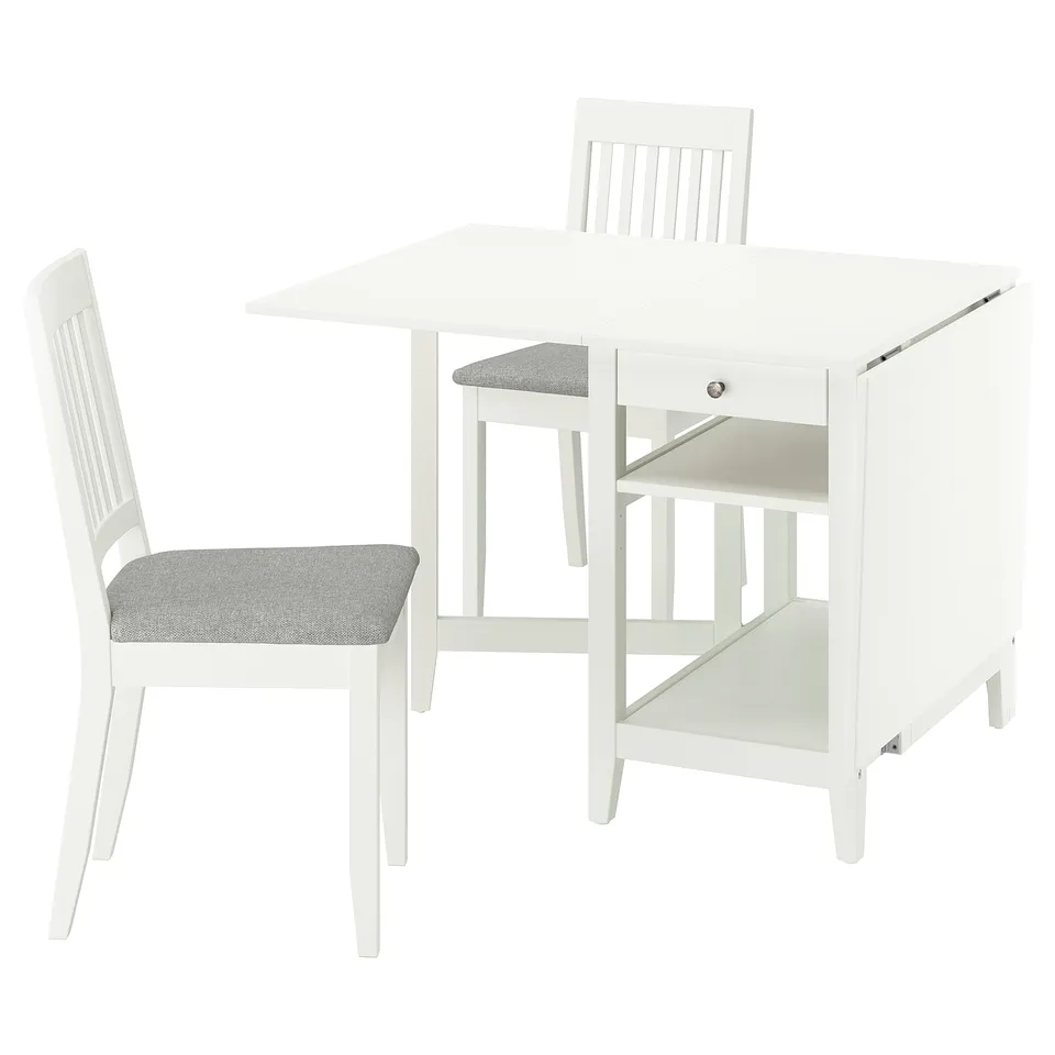 White drop-leaf dining table with storage, two matching chairs with grey cushions, compact and simple design.