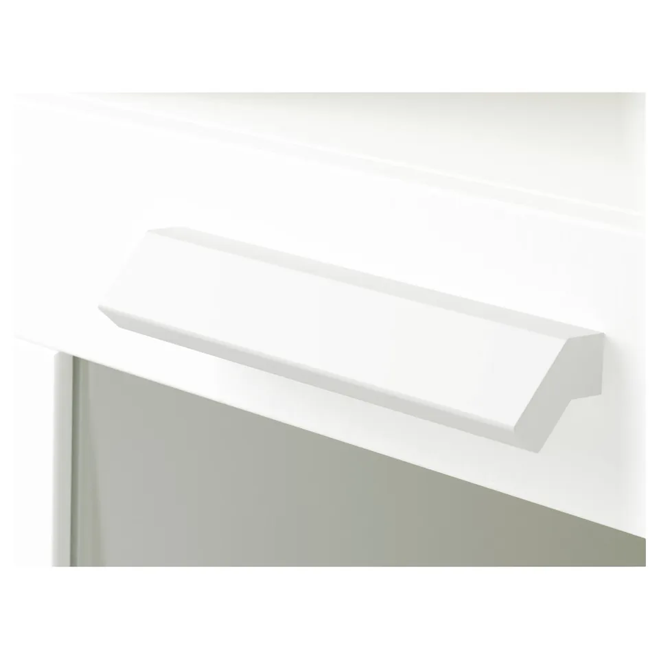 A close-up of a white shelf edge on a wall-mounted unit, highlighting its smooth and sleek design.