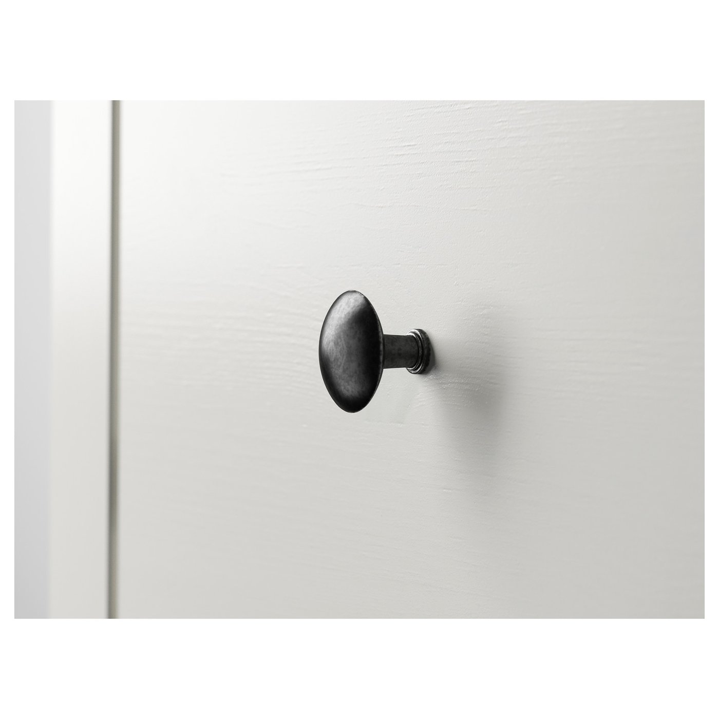Black metal hook on white wall, simple & sturdy design.