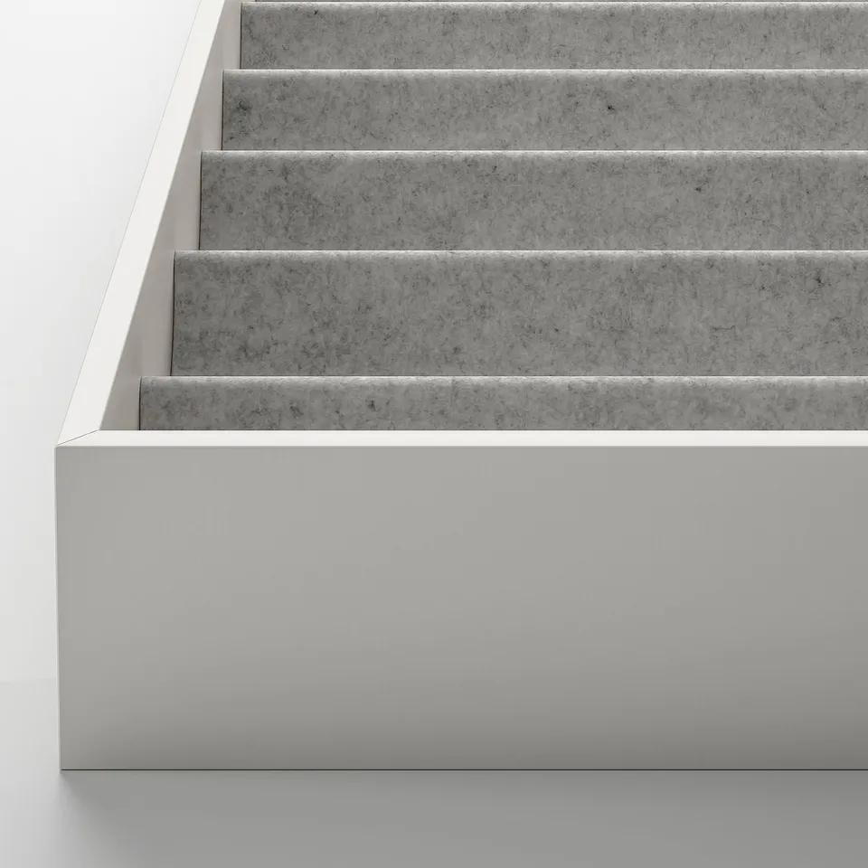 Modern staircase with clean, smooth, light-colored steps and sides, meticulously crafted.