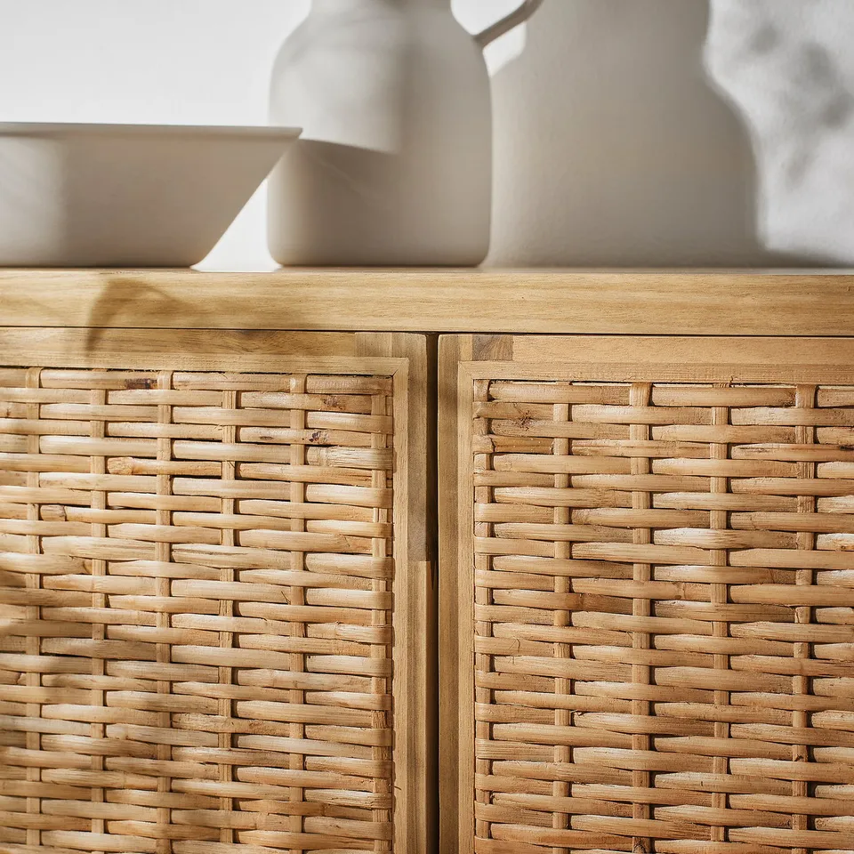 Close-up of FRYKSÅS cabinets woven wicker and acacia wood doors, showing intricate craftsmanship and natural texture.