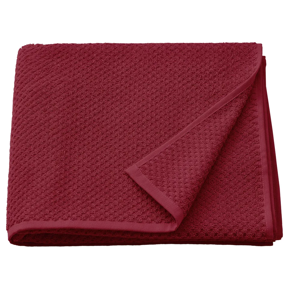 This image a red GULVIAL towel, folded neatly. Made of 100% cotton, its soft and fluffy, ideal for everyday use.