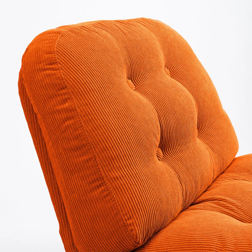 Orange corduroy chair with intricate stitching.