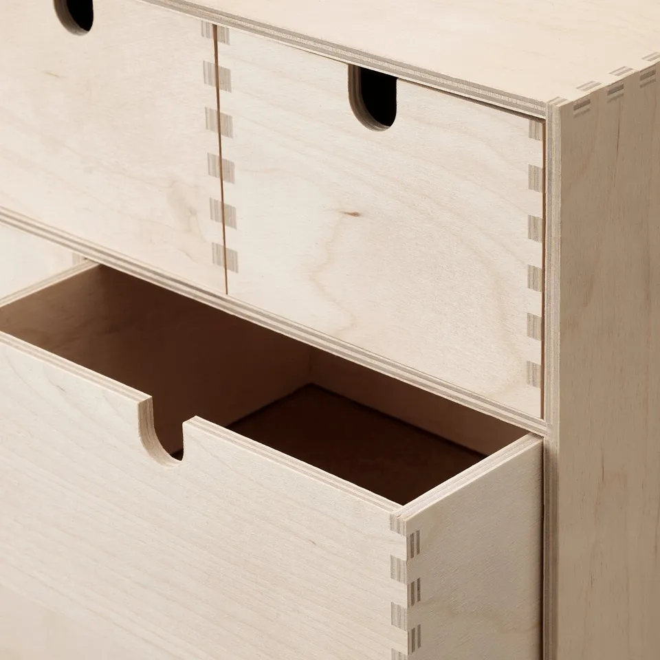 Close-up of MOPPE chests quality wooden drawers, showcasing precise craftsmanship and natural finish.