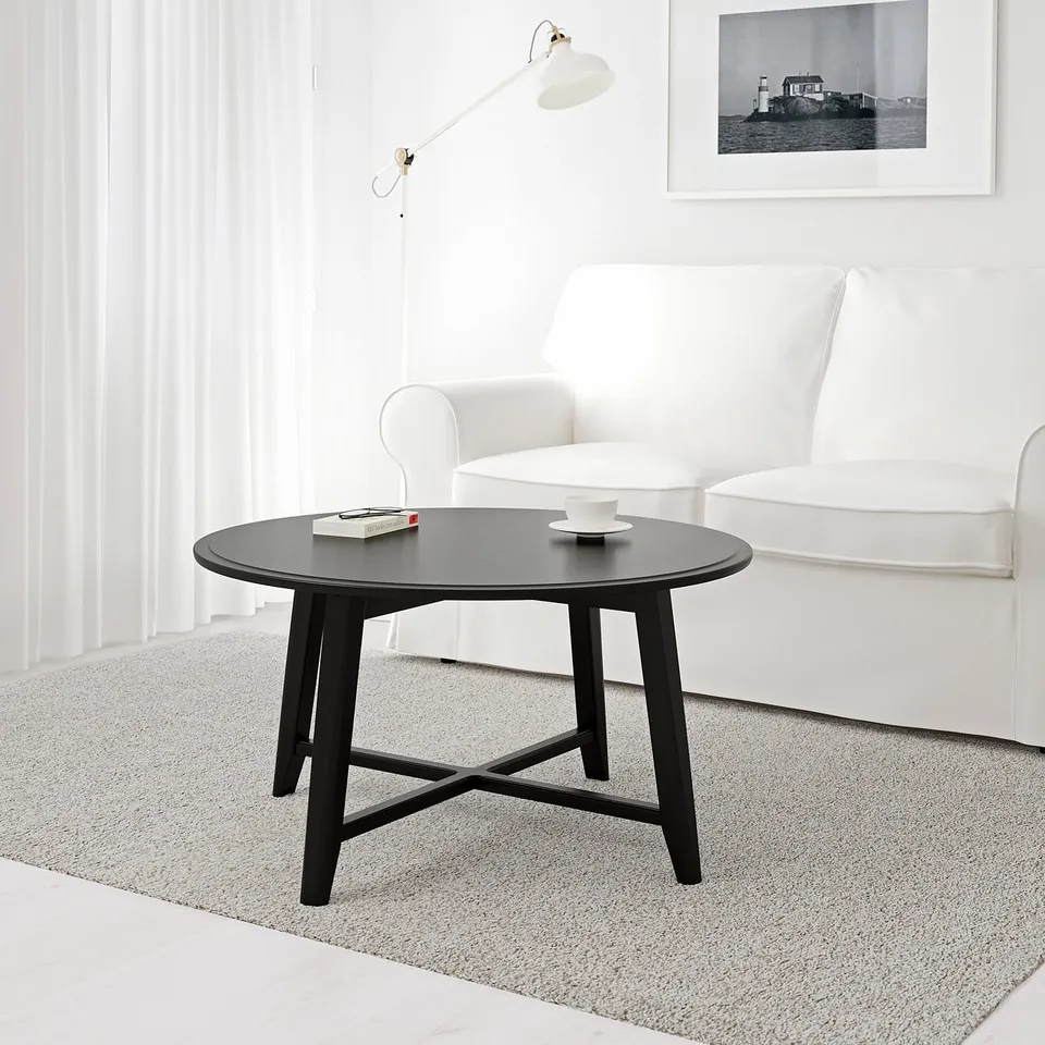 Modern living room with KRAGSTA table and white armchair.