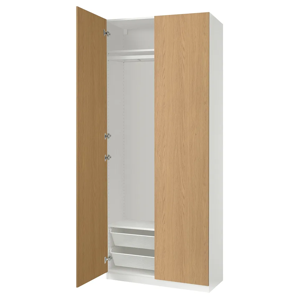 An open wood and white PAX wardrobe with shelves and rail.