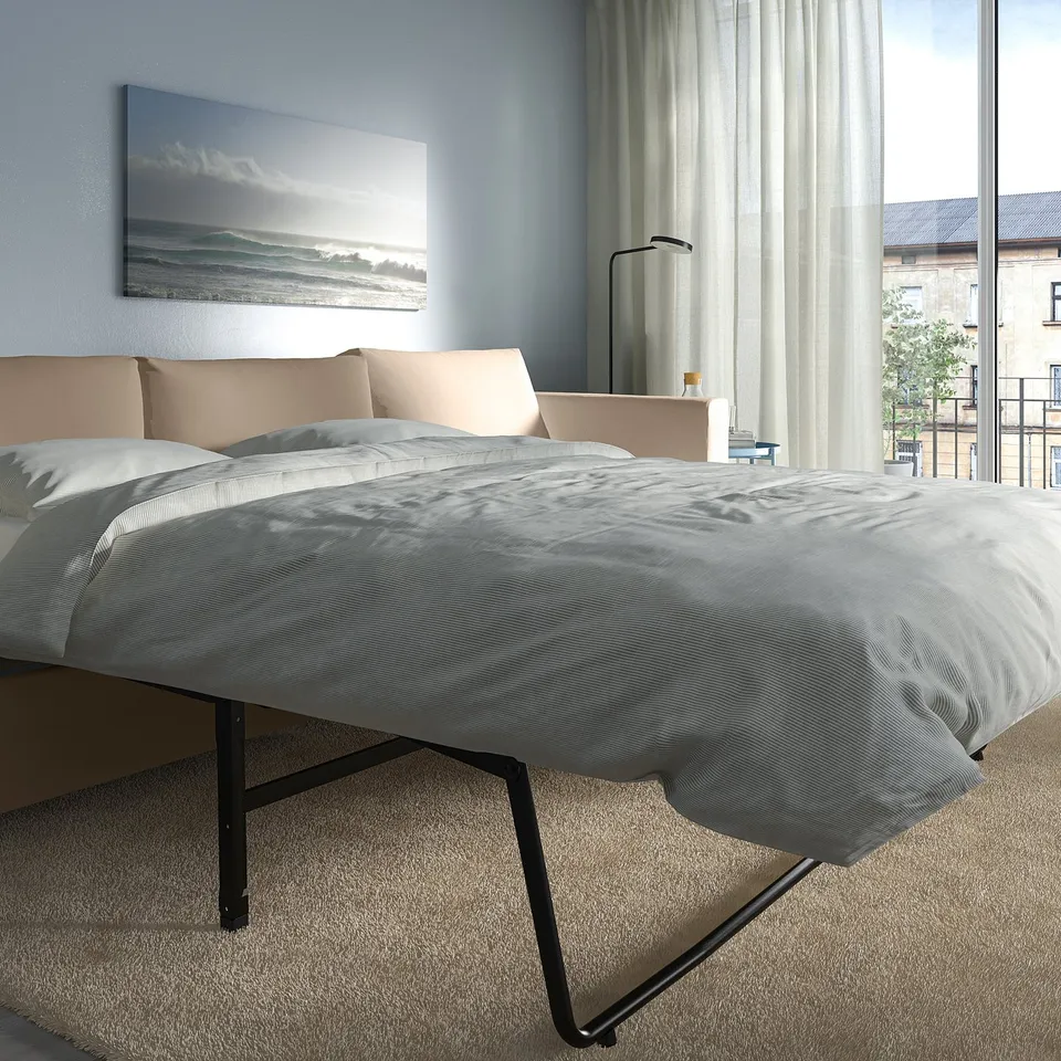 Modern bedroom with VIMLE sofa-bed and grey bedding, large window, sheer curtains.