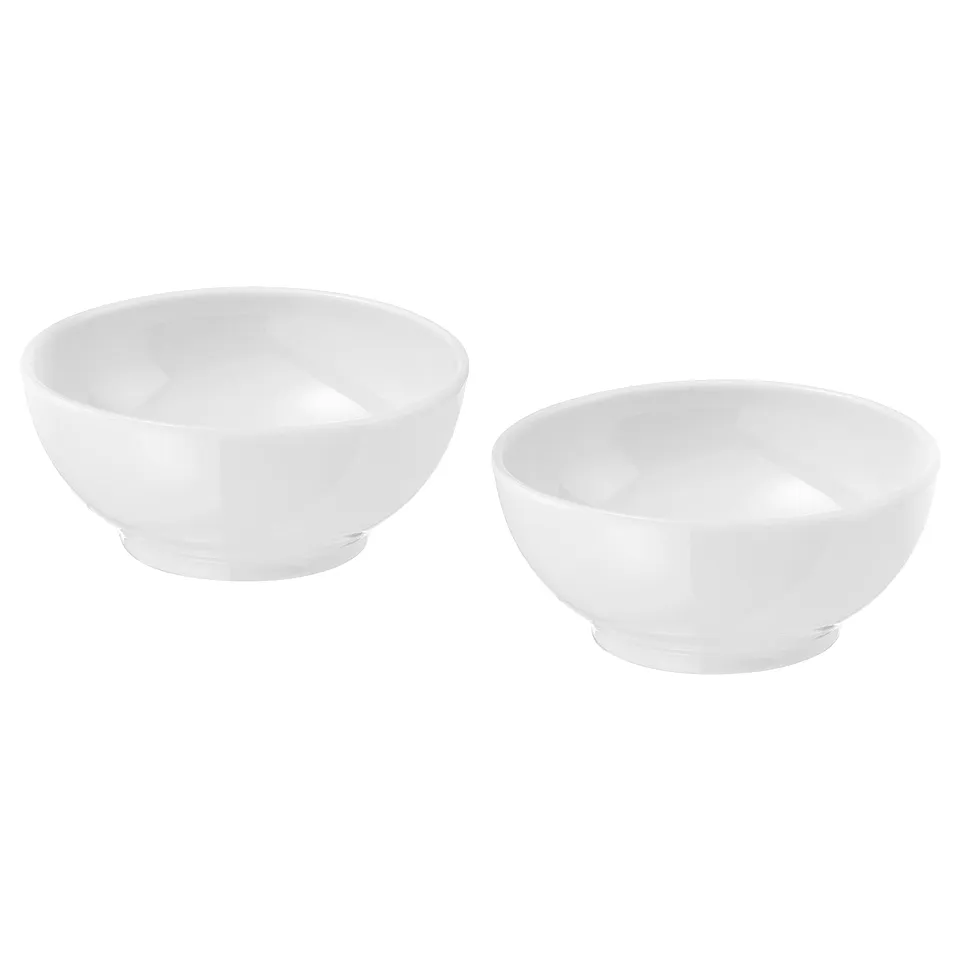 Two white porcelain bowls by IKEA 365+, simply designed for everyday use, stackable, durable.