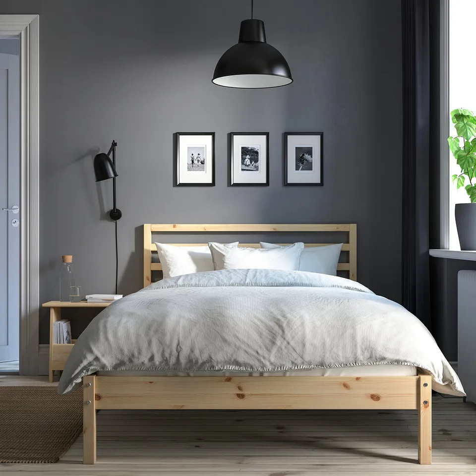 Modern bedroom: TARVA bed, white bedding, dark grey walls, plant, cosy decor.