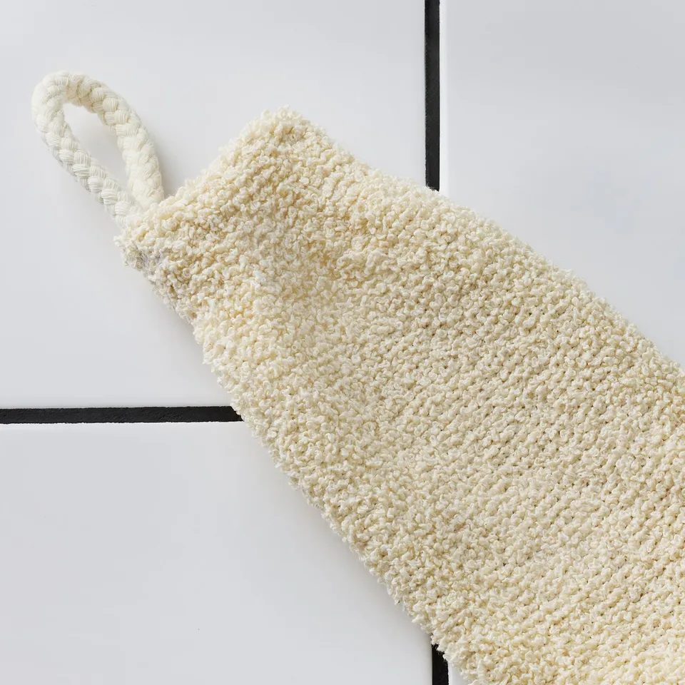 Handcrafted exfoliating mitt, textured for gentle scrubbing, hanging loop for convenience.