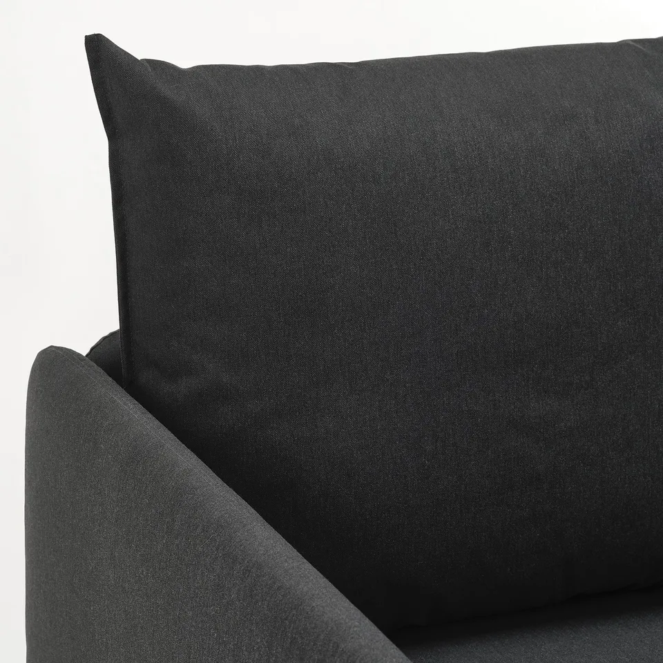 Black sofa cushion close-up, plush and textured, showcasing high-quality upholstery.