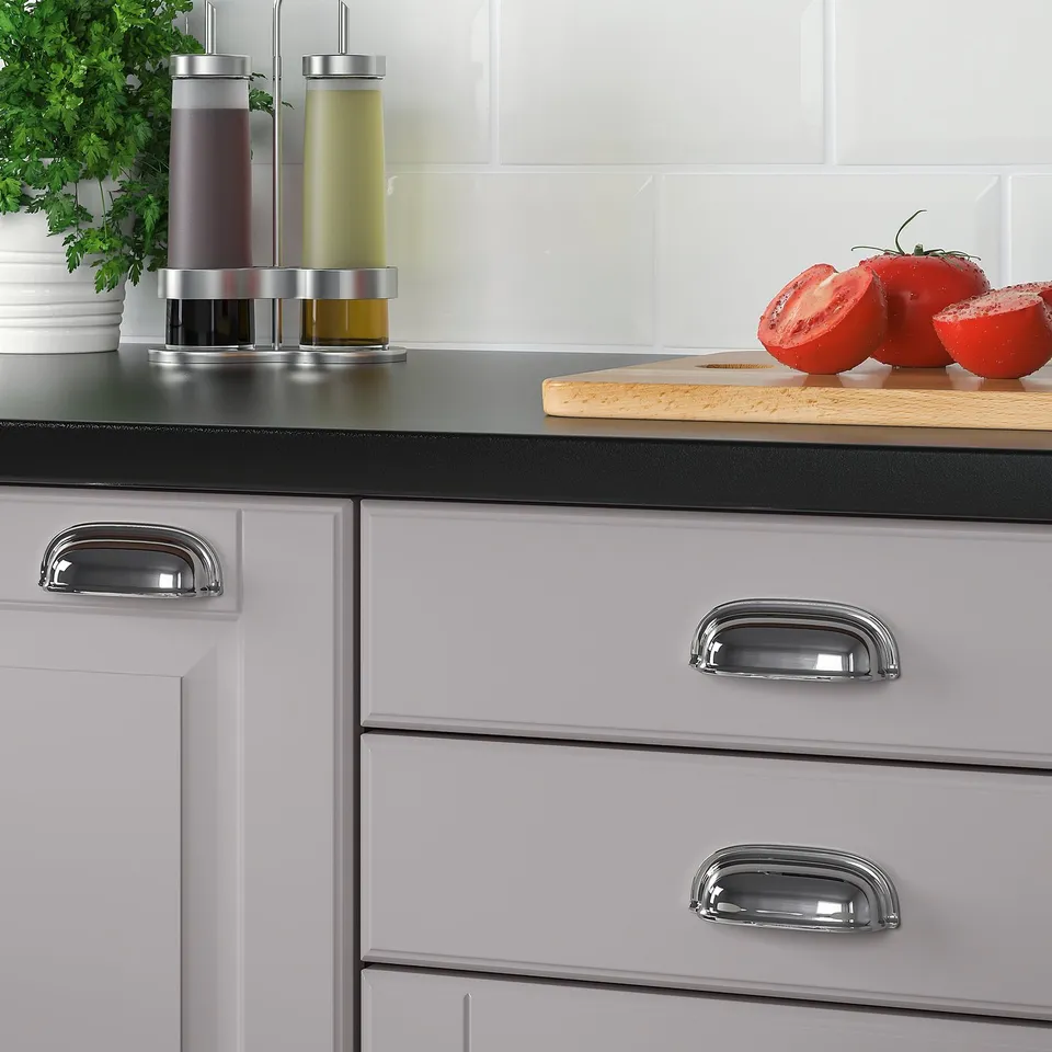 Modern kitchen cabinets with chrome handles and knobs showcasing a sleek, traditional design.