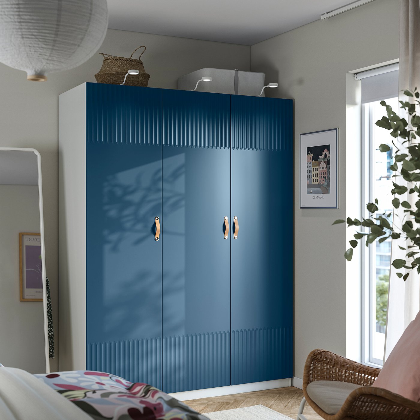 Modern compact blue wardrobe, designed for couples, fits corner perfectly. Tall, sleek design with gold handles.