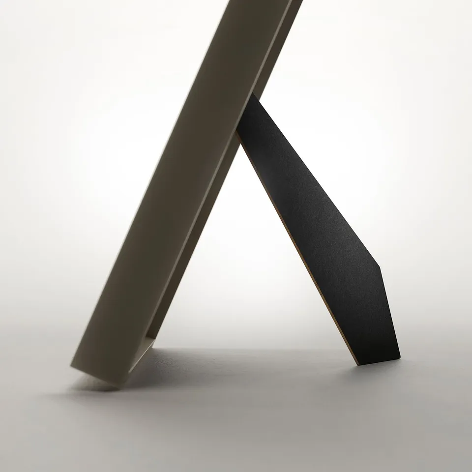 Metal picture frame displayed as a stand. Modern design, can hang or stand vertically or horizontally.
