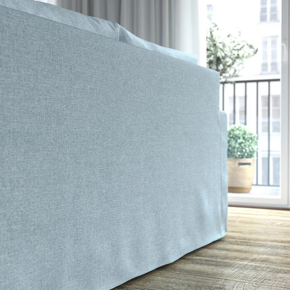 Light blue sofa with a sleek, classic design, positioned near a window with potted plants outside, offering a cosy and inviting seating area.