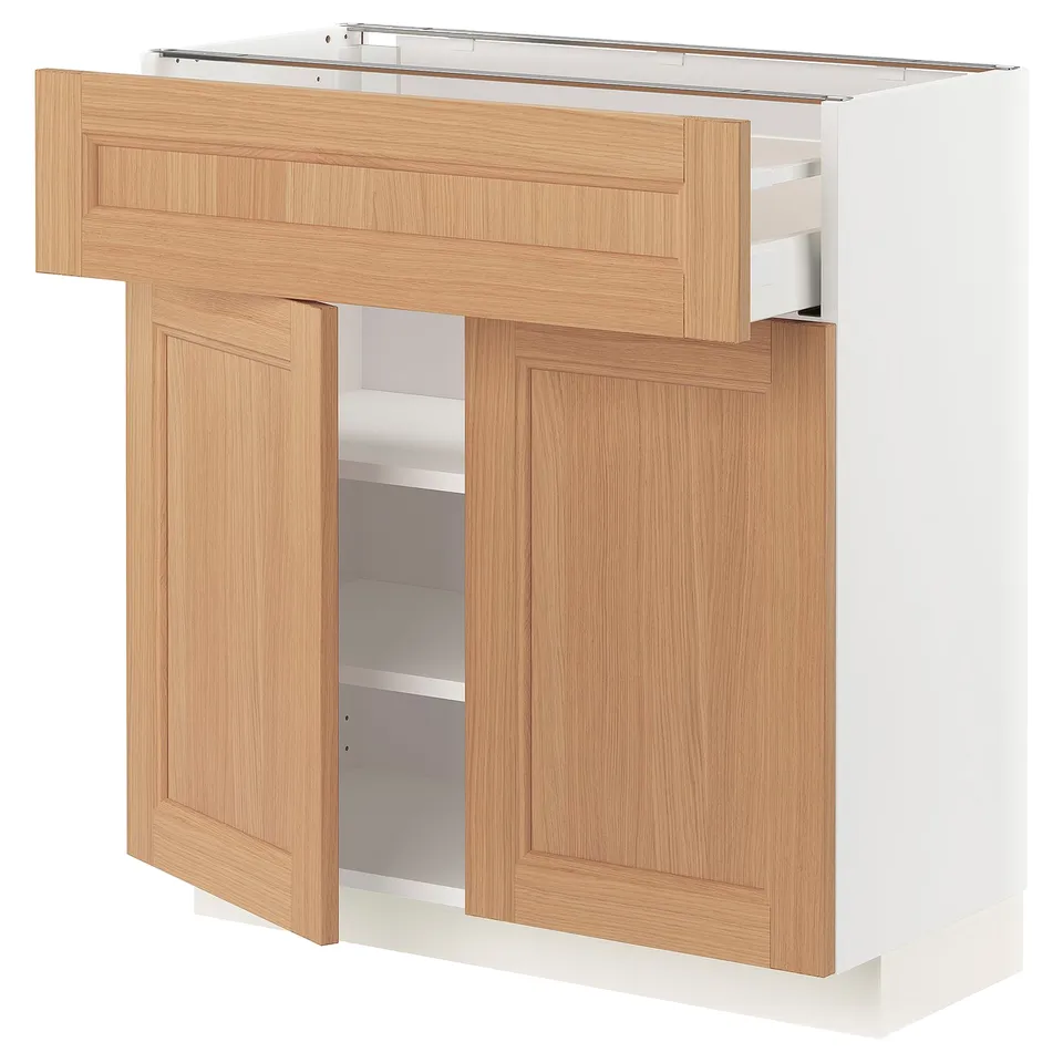 Light wood and white cabinet with open drawer and shelves. Modern kitchen storage unit.