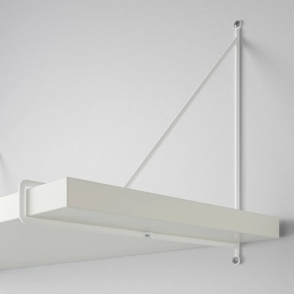 White wall-mounted shelf with angled support brackets, securely attached to a plain wall, displaying minimalistic design and sturdy build.