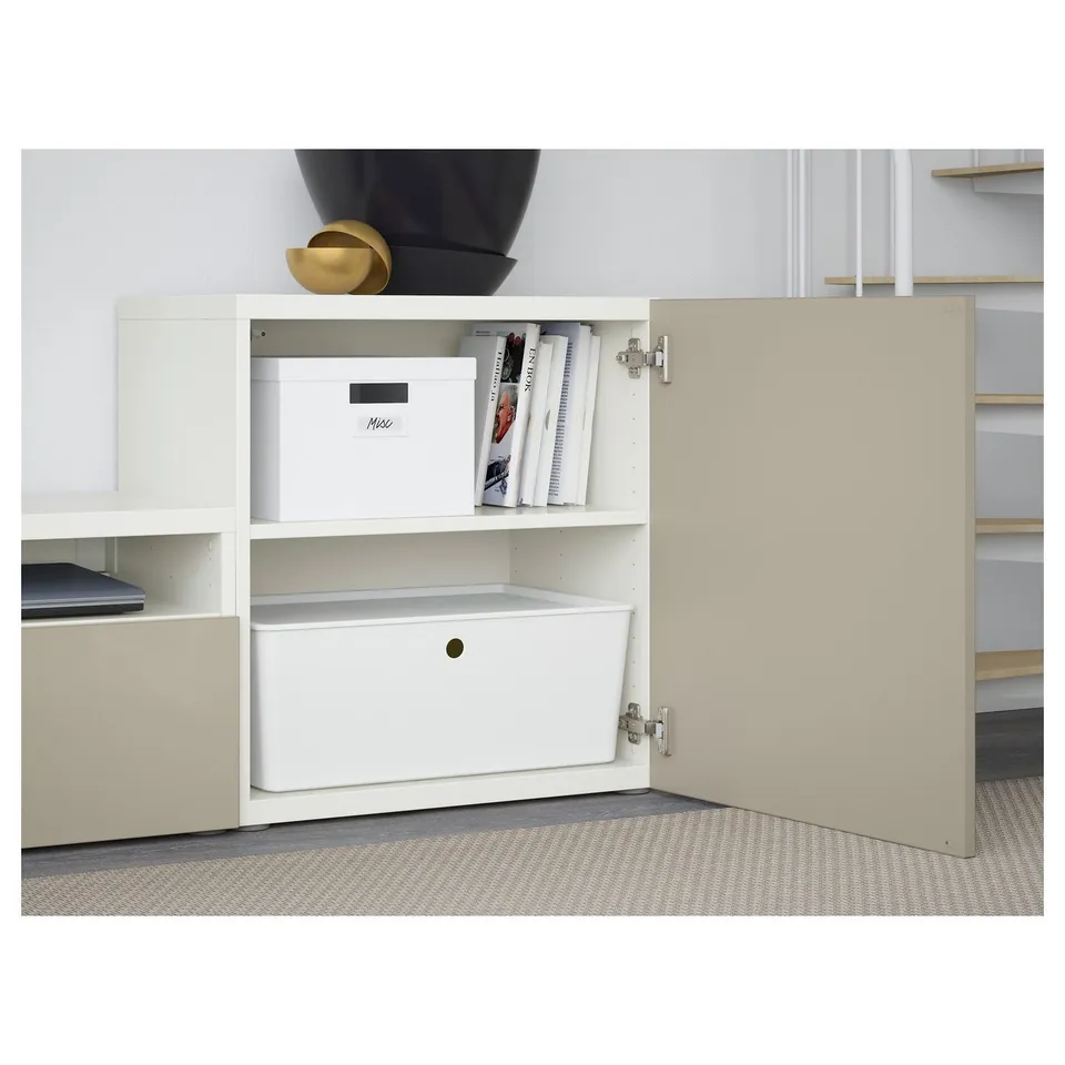 Open BESTÅ unit showcasing adjustable shelves with storage boxes and magazine files, soft-close hinges visible.