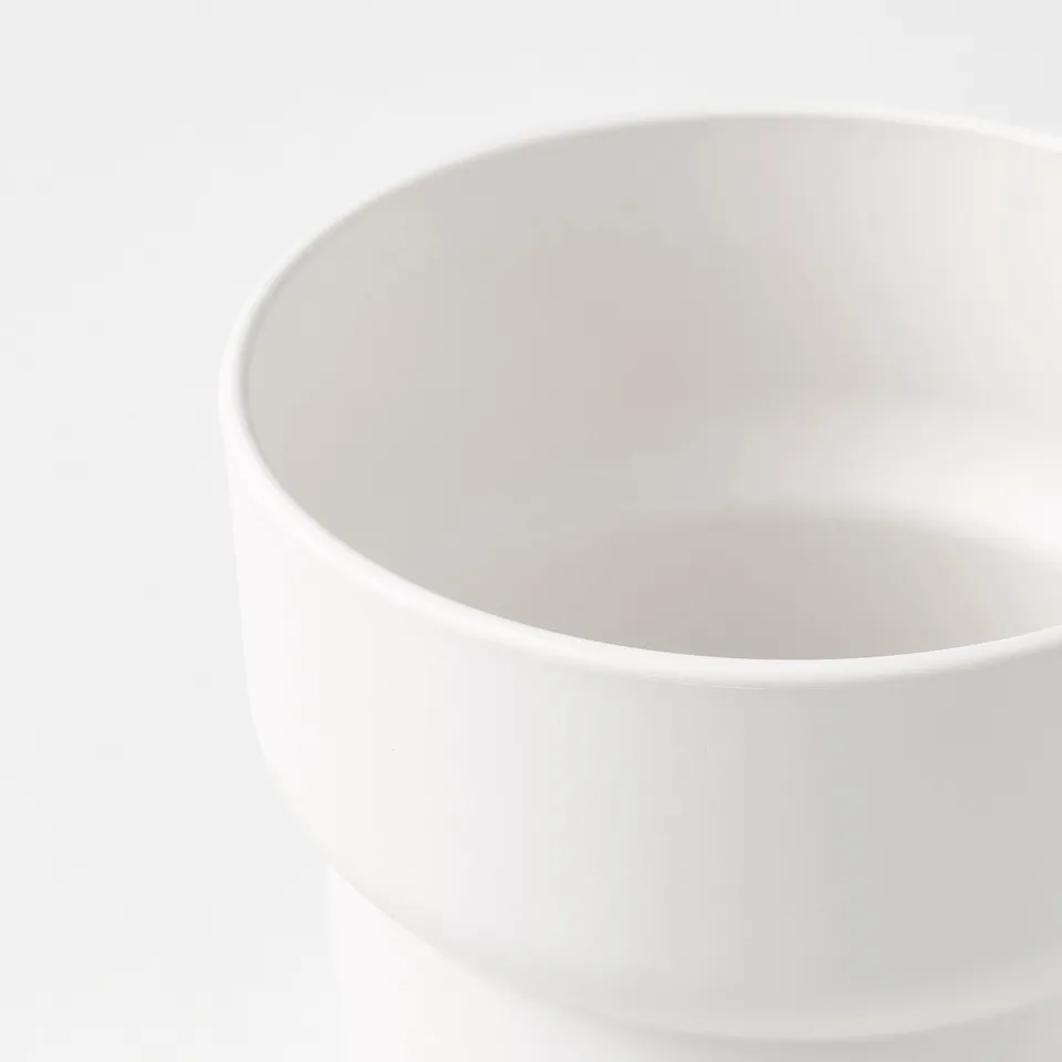 Precision-crafted white plastic planter with smooth, rounded edges. Simplistic and durable, suitable for indoor or outdoor use.