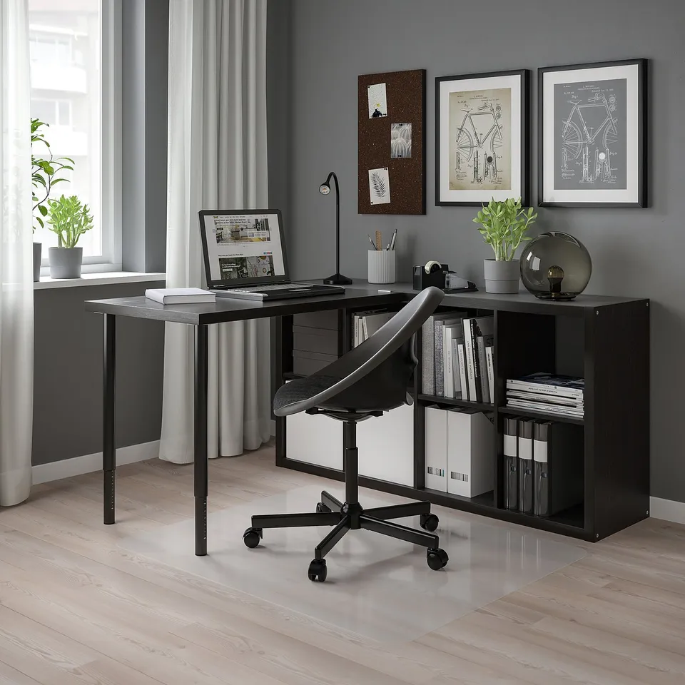 Modern black home office setup with KALLAX shelving, wooden floor, grey walls, large window, desk with laptop, black chair, and decorations.