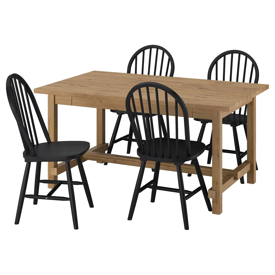 The NORDVIKEN dining set with a light brown table and four black chairs, designed for extended use with self-storing leaves.