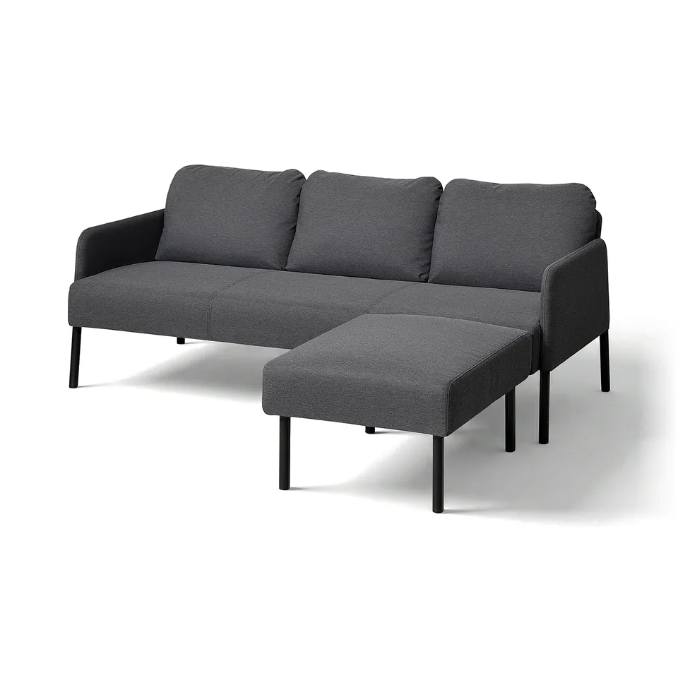 Modern dark grey GLOSTAD sofa with attached footrest, minimalist design.