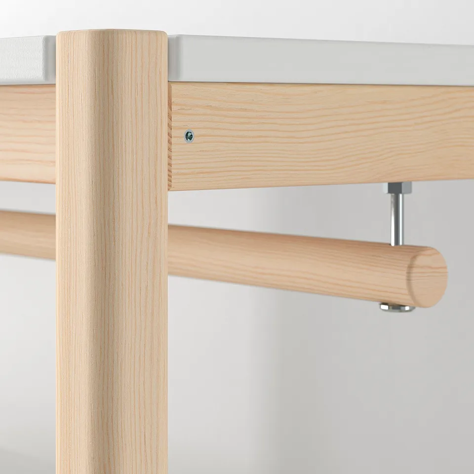 Close-up view of wooden furniture with metal connectors showcasing high-quality craftsmanship and natural finish.