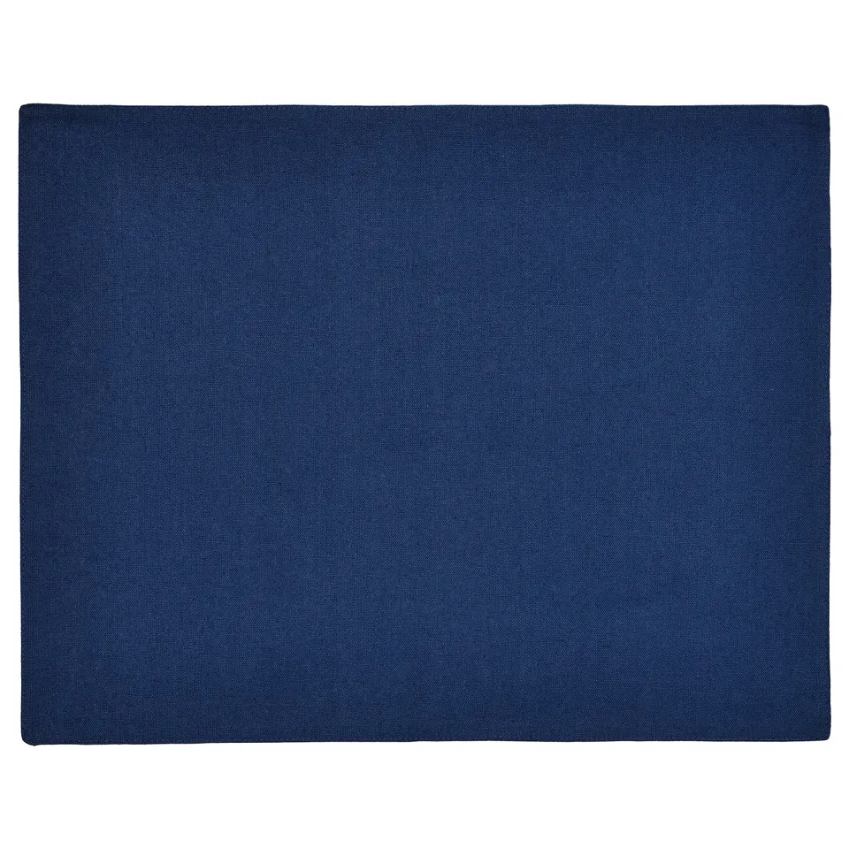 Reversible cotton-jute place mat, solid/navy dotted side, for table settings.