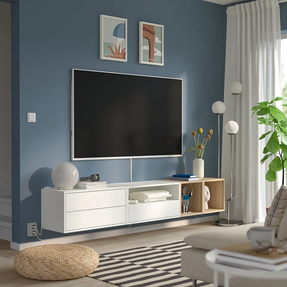 Modern living room with flat-screen tv, EKET unit, plants, and decor.