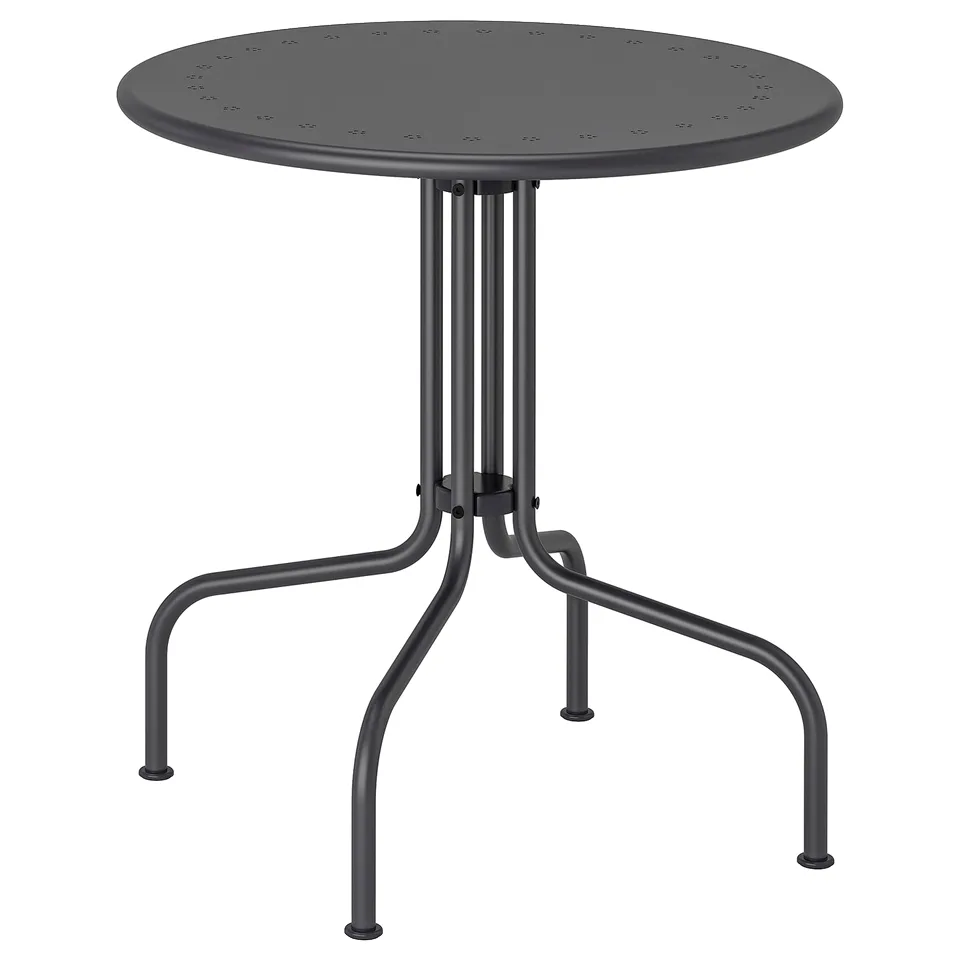 A small, round, black outdoor table from the LÄCKÖ series with a perforated steel top and four curved metal legs.
