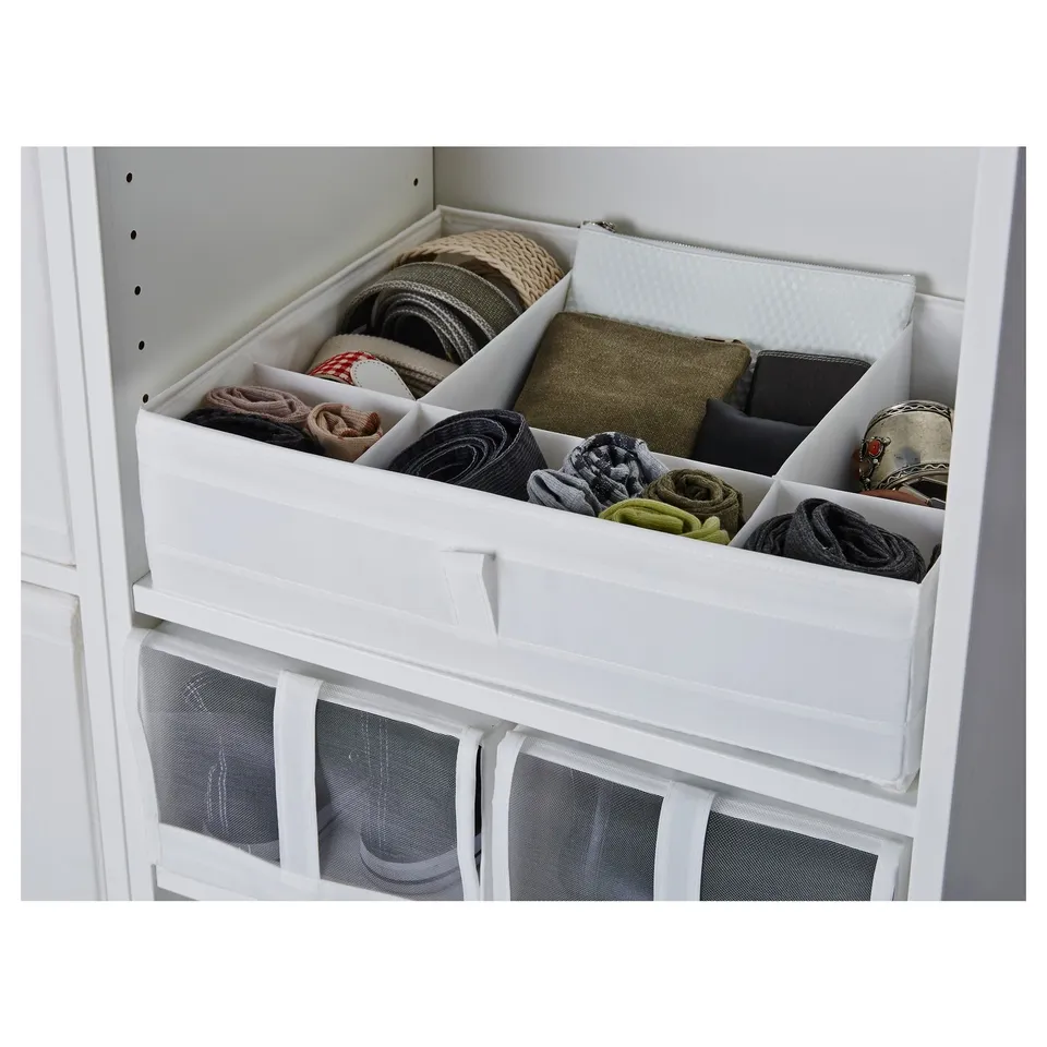 Organised drawer with multiple compartments holding socks, belts, and accessories. The SKUBB box handles on both sides for easy access.