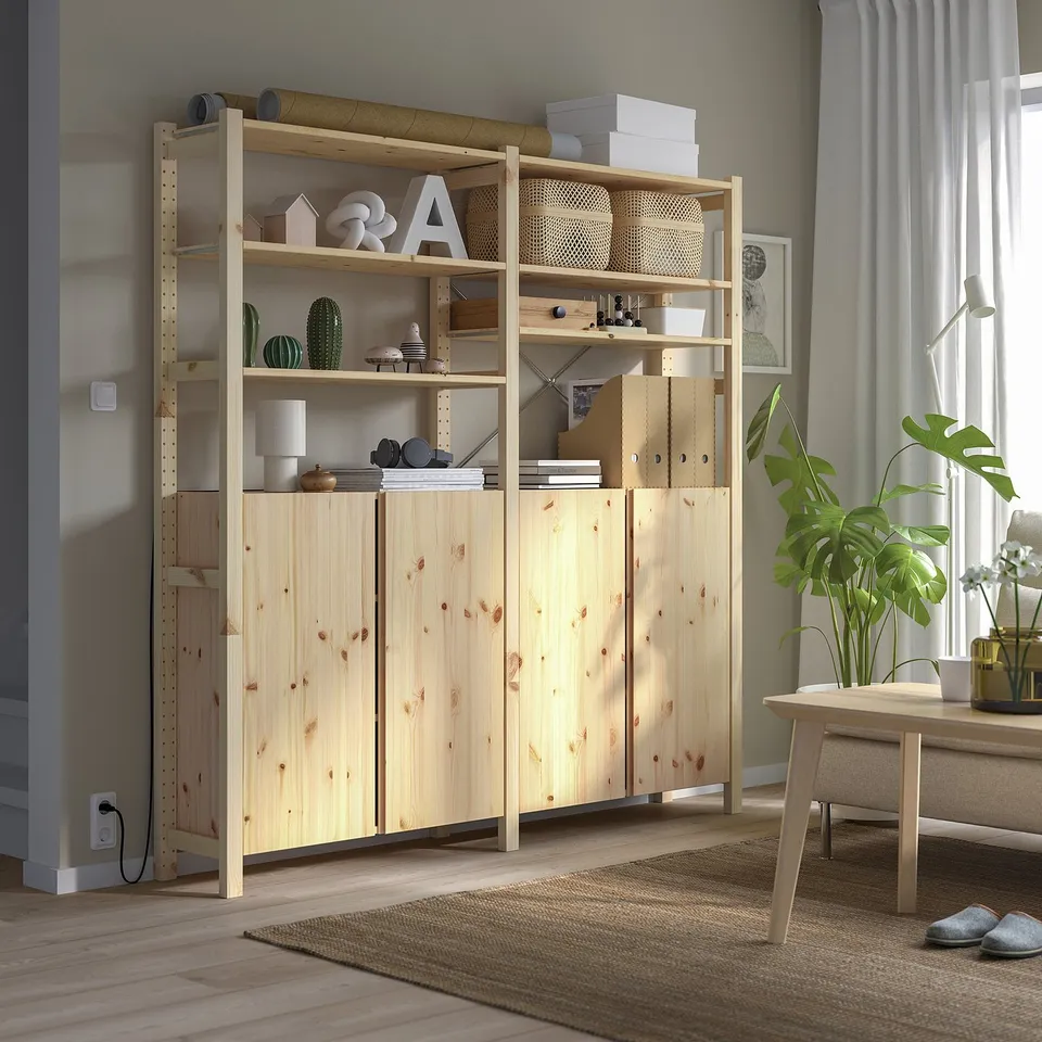 Wooden IVAR storage unit with plants and decor, adjustable shelves, taller than table.