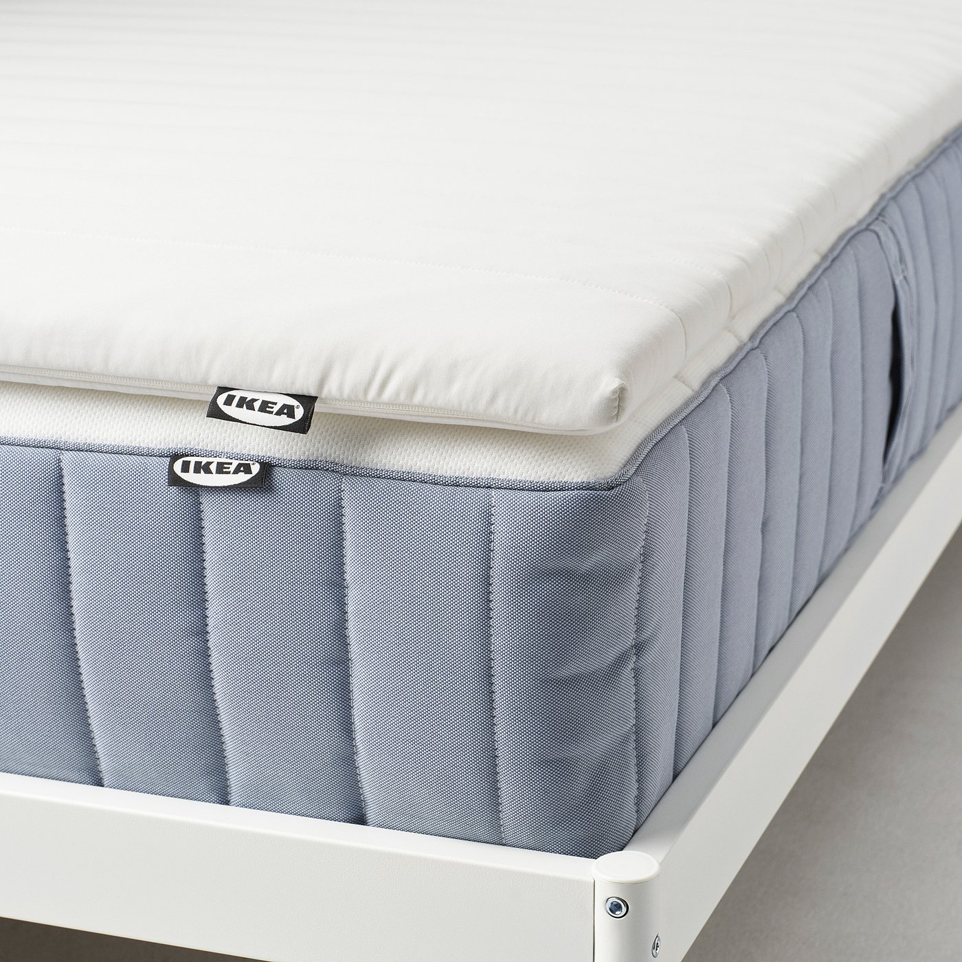 Ikea mattress pad, double-sided & washable, adds softness and comfort.