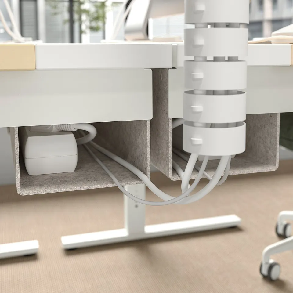 Desk with cable management tray and height adjustment feature.