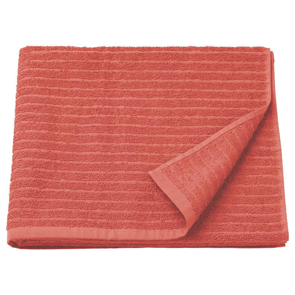 Bright coral orange VÅGSJÖN towel, rectangular, 100% cotton with soft ribbed design.