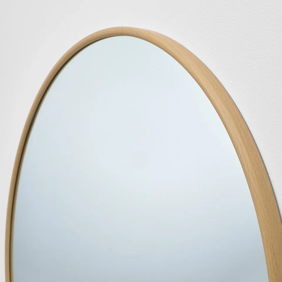 A high-quality EDSGARN mirror with a thin, rounded oak-effect aluminium frame. Its designed to enhance room decor and add depth.