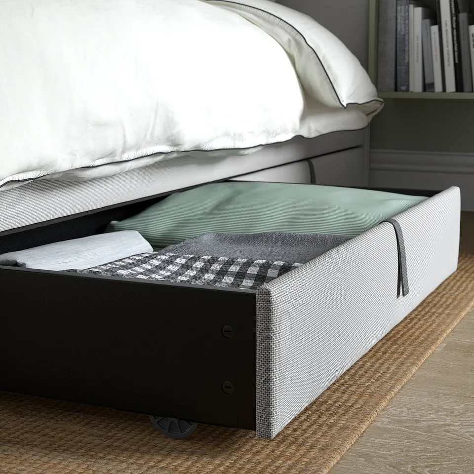 Under-bed storage box system with fabric cover, easy to roll in and out, offering practical storage space.